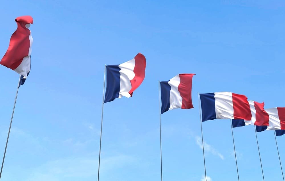 France flag waving on blue sky background