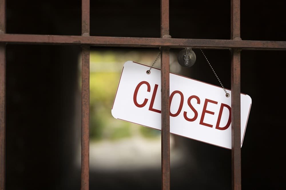 White closed sign hanging on bar
